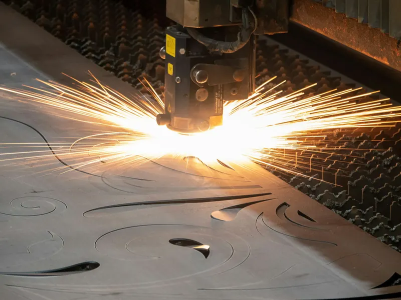 A laser cutter cuts a steel sheet.